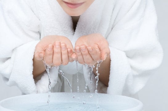 Woman Washing Face With Water